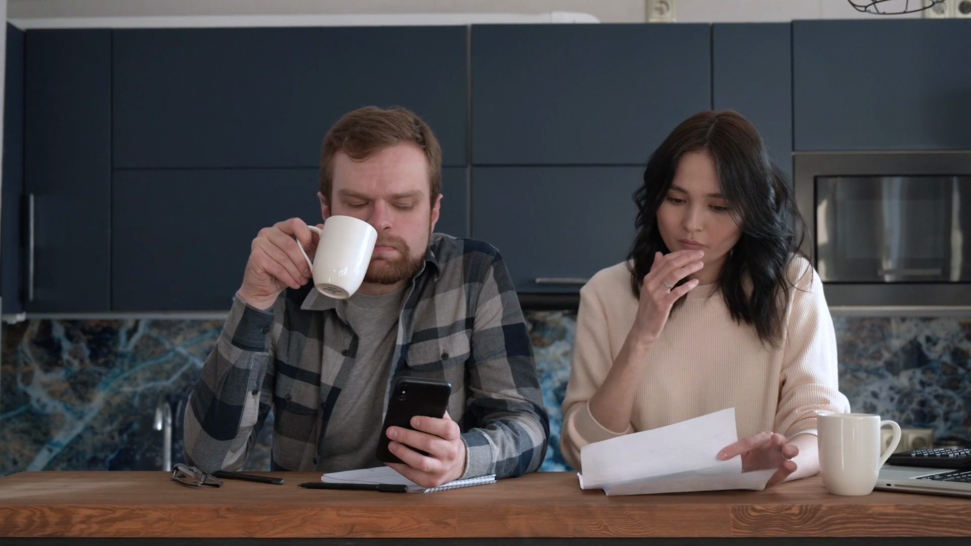 A household reviewing a power bill at a kitchen table